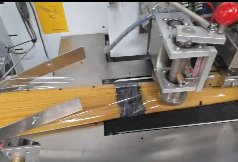 Pasta flow wrap machine